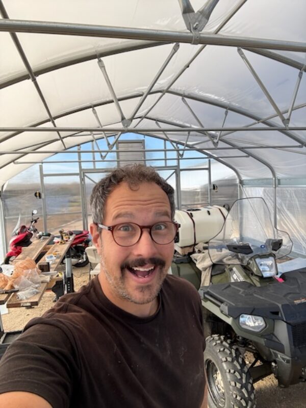 Alex from Windflower Natives setting up their new greenhouse.